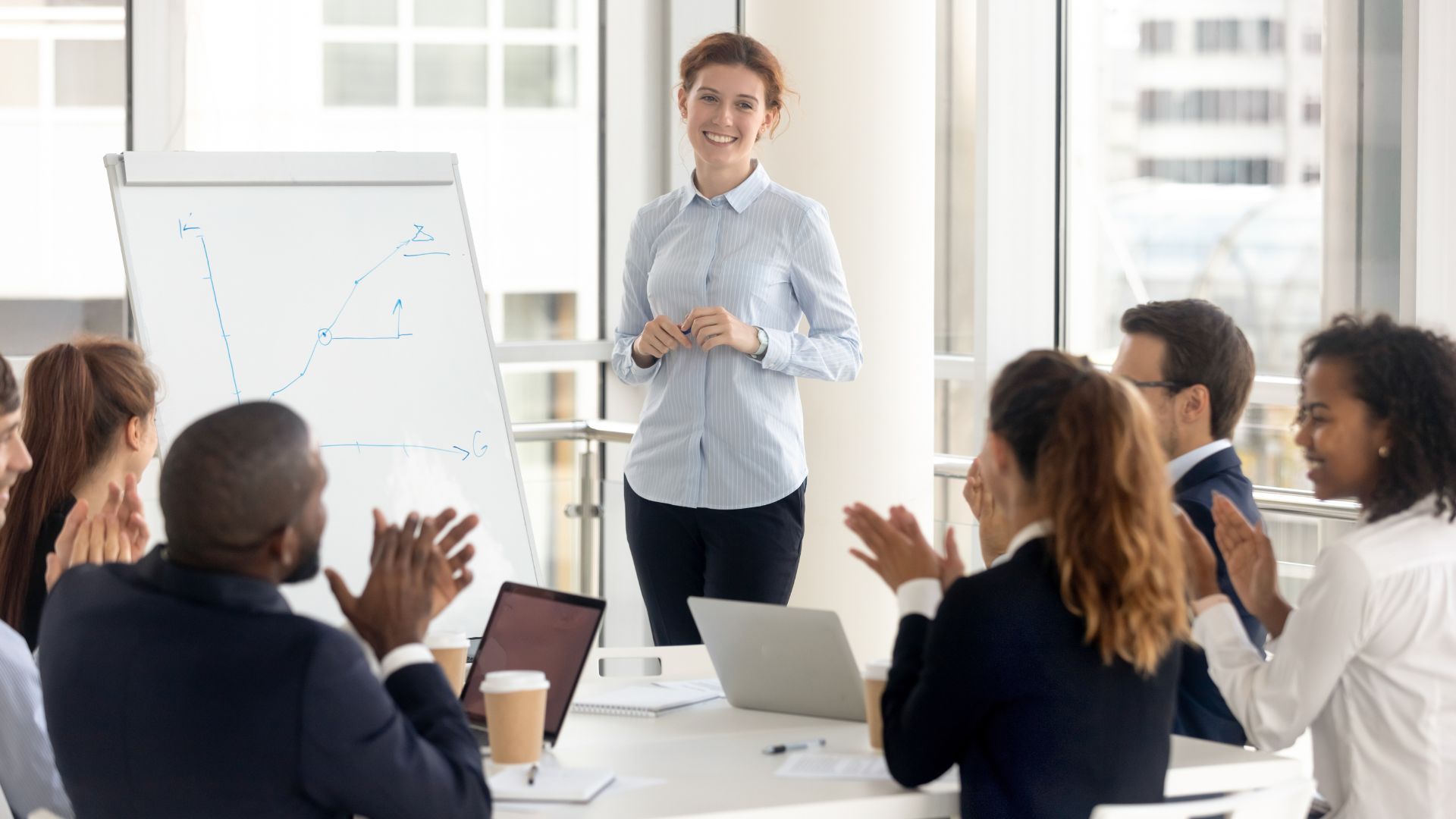 A person giving a presentation to a group of people - Real Estate Sales LLC