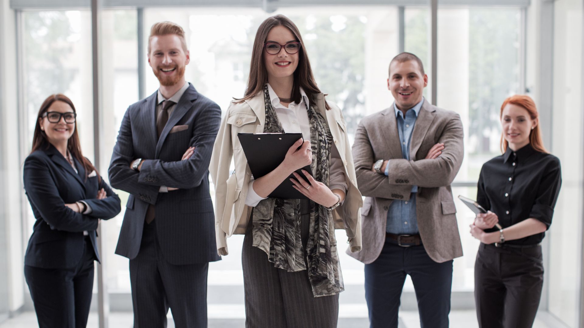 a group of Real Estate people standing in an office - Real Estate Sales LLC